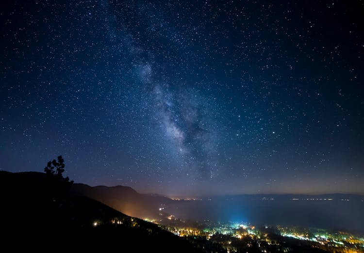 City With Lights Under A Starry Sky