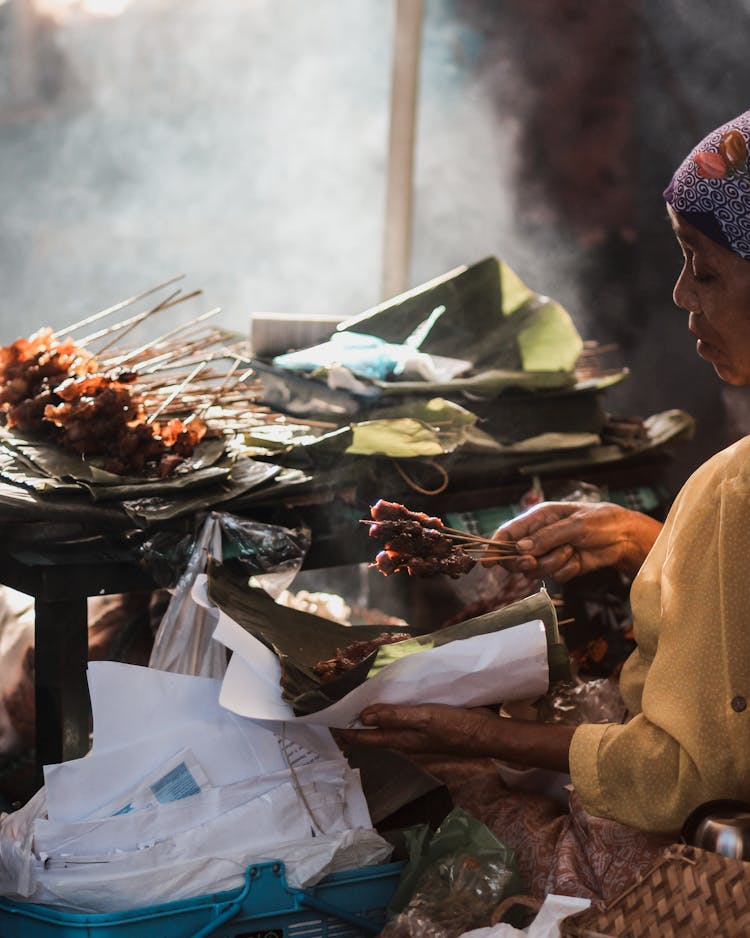 Person Holding Skewers