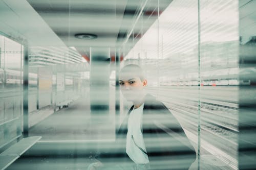 Person in Black Jacket Sitting Near Window