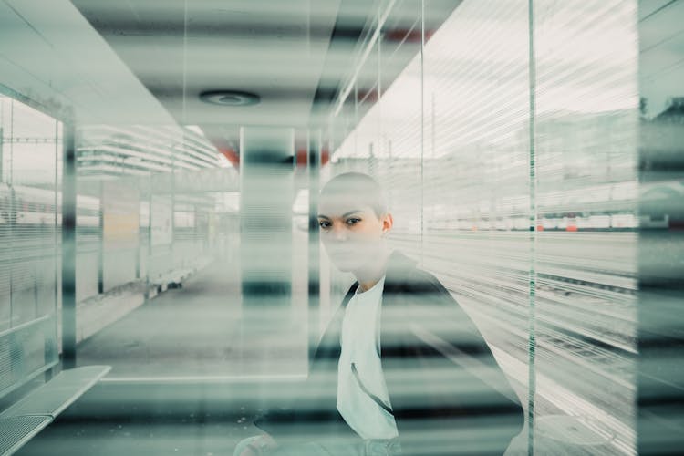 Person In Black Jacket Sitting Near Window