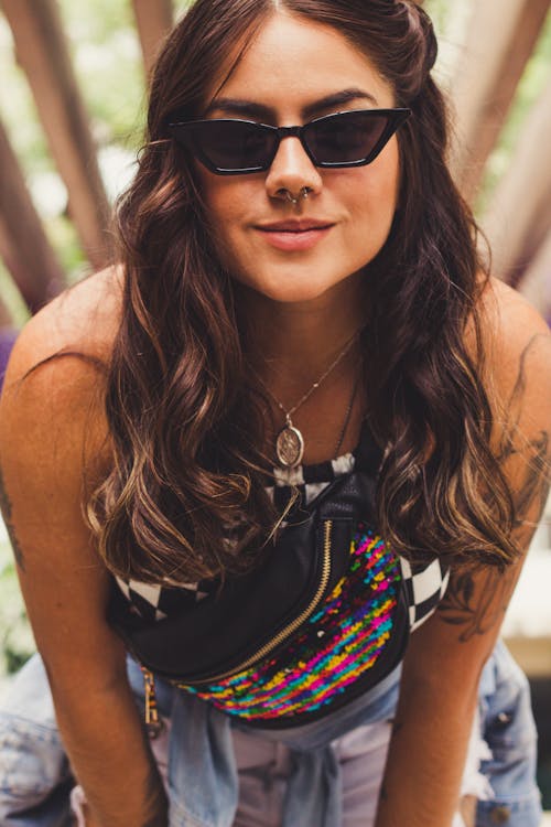 Femme En Lunettes De Soleil Noires Se Penchant Vers La Caméra