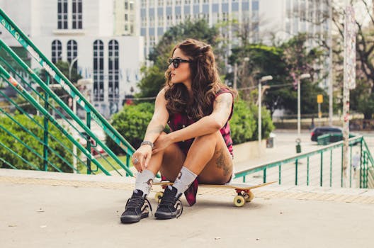 一位穿着休闲服、戴着太阳镜的时尚女性，正坐在城市街头的滑板上