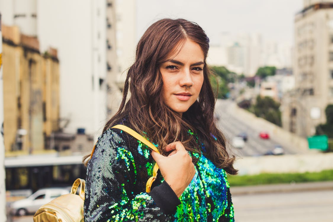 Portrait Photo of Woman in Sequin Jacket Carrying Backpack Posing