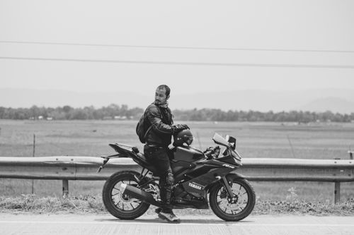 Free A man with a mustache sits on a Yamaha motorcycle on a rural road in India. Stock Photo