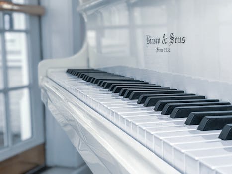 A beautifully crafted white piano with a classic design, capturing tranquil elegance in a sunlit room.