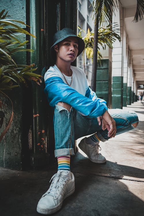 Man Wearing Blue Denim Bucket Hat and Blue Jacket