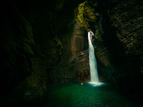 Breathtaking waterfall flowing through the rocky Soča Gorge in Tolmin, Slovenia.