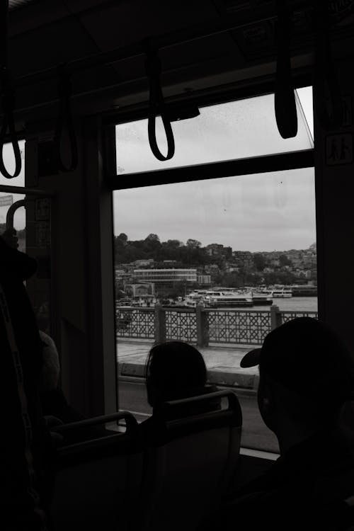 A black and white photo of people on a train