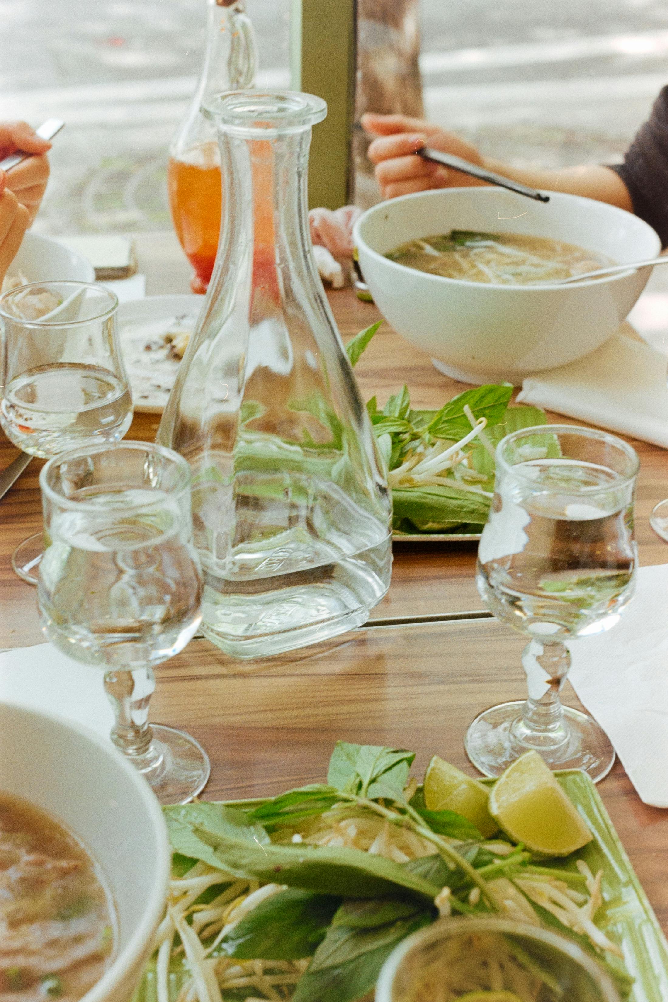 Enjoying Vietnamese Pho at a Parisian restaurant with fresh ingredients and elegant tableware.