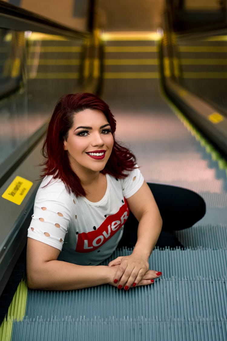 Woman Sitting On Escalator