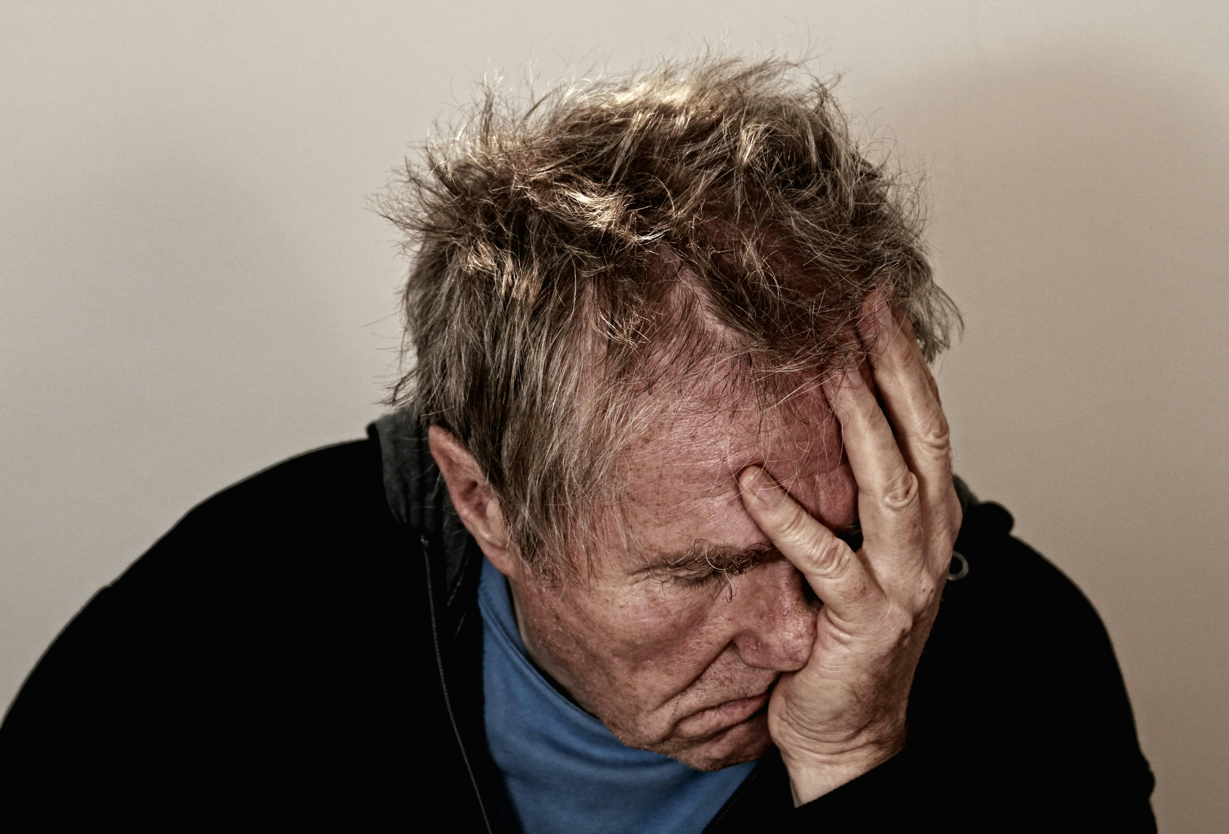 man holding his face