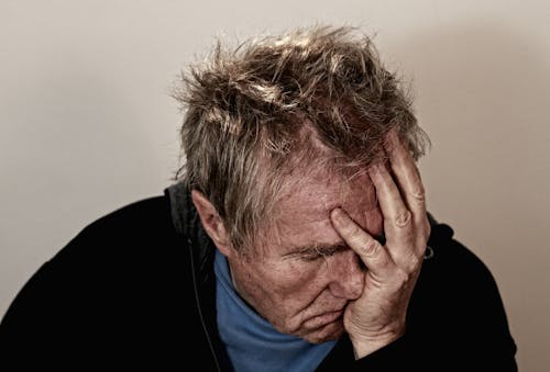 Free Man Holding His Face Stock Photo