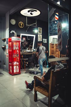 Stylish barbershop featuring a retro phone booth and modern interior decor.