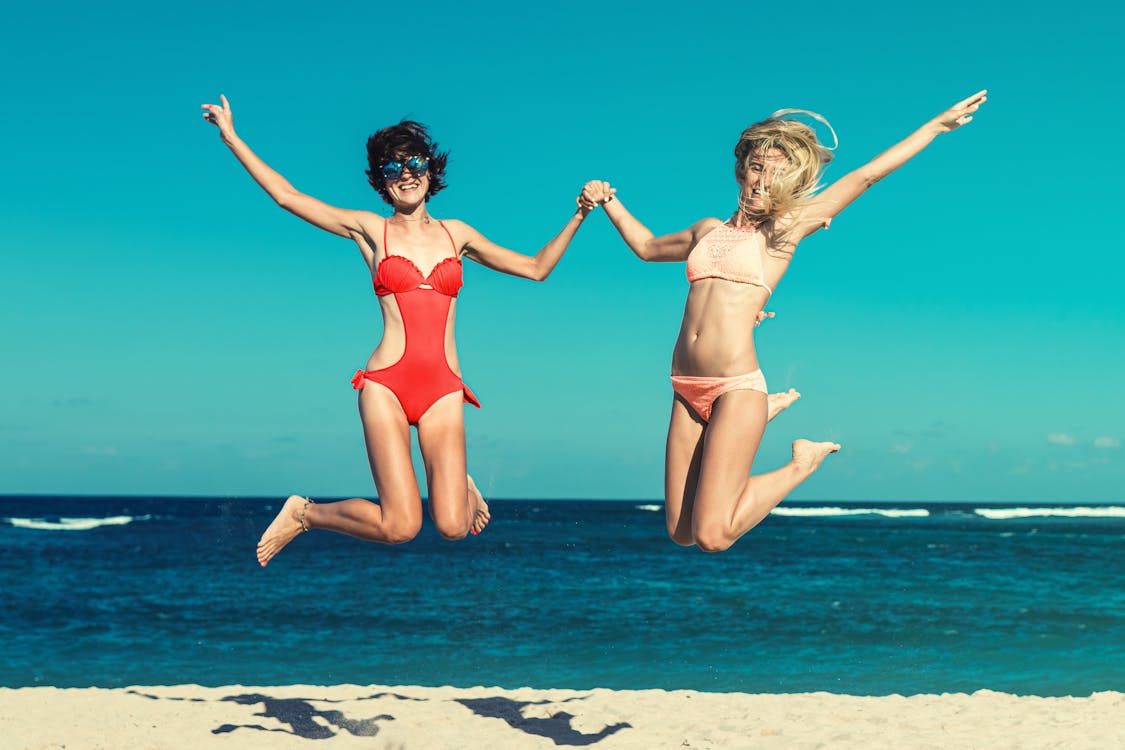 Free Two Woman in Bikini Jumping Stock Photo