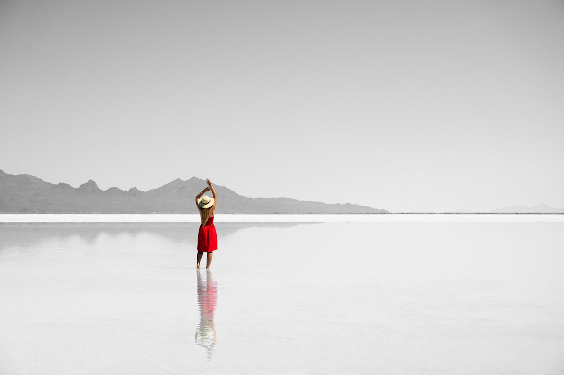 Free Woman Standing In The Middle Of The Sea Stock Photo