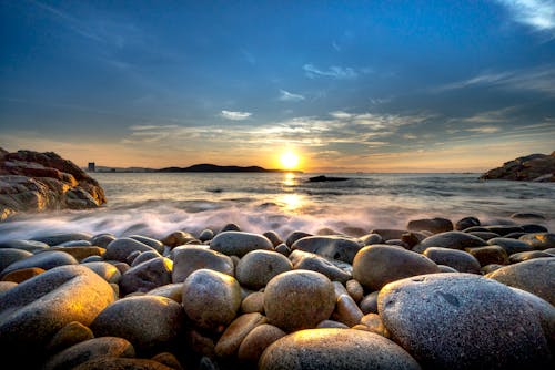 Free Rocky Beach during Sunrise Stock Photo