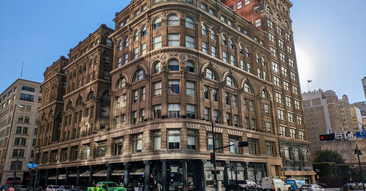 Low angle view of the iconic Wilson Building in Dallas, Texas, showcasing urban architecture.