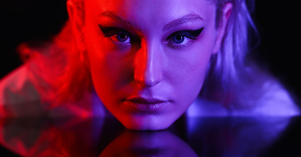 Split Light Color Portrait of a Young Woman in Split Lighting · Free Stock Photo