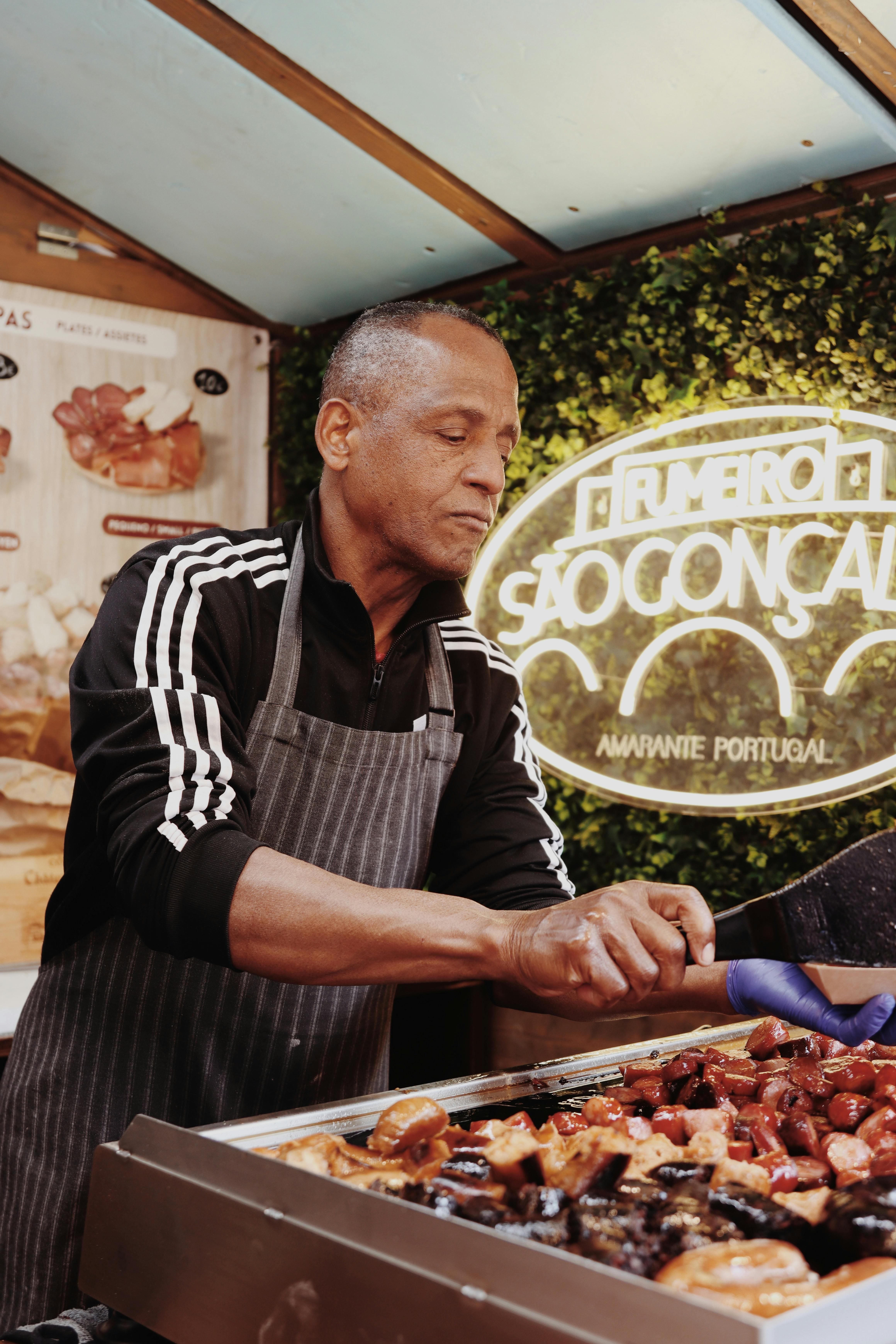 Street food vendor grilling Portuguese cuisine in Lisbon, Portugal.