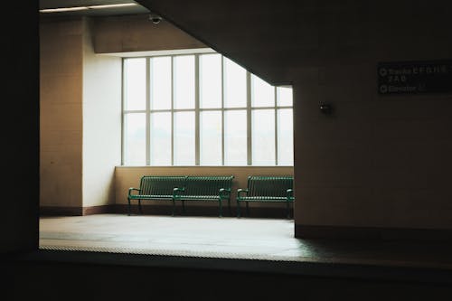 A bench in a train station with a window