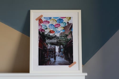 White Wooden Framed Picture of Assorted Color Umbrellas