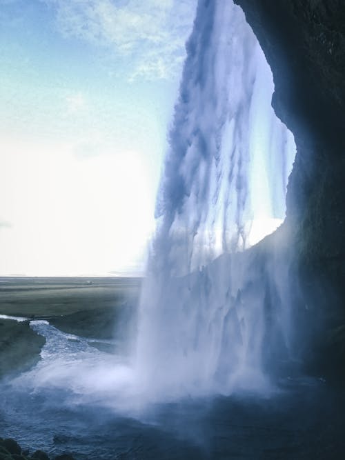 Raging Waterfalls Under White Clouds