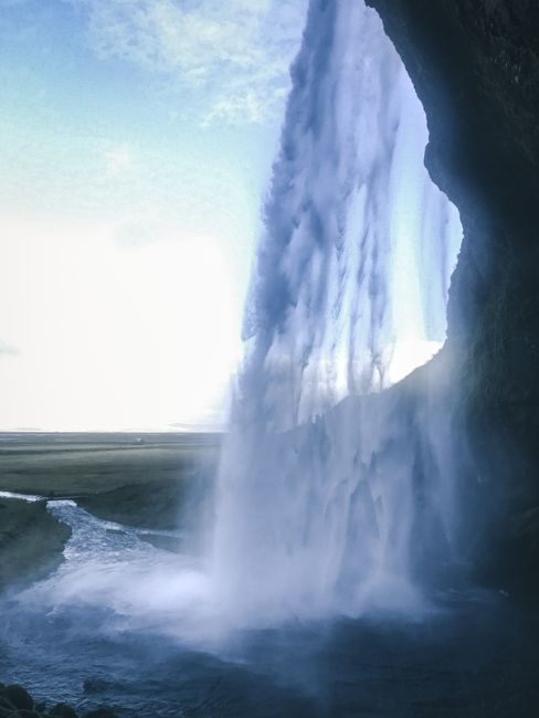 Stunning view of a cascading waterfall in Iceland, captured in summer daylight.