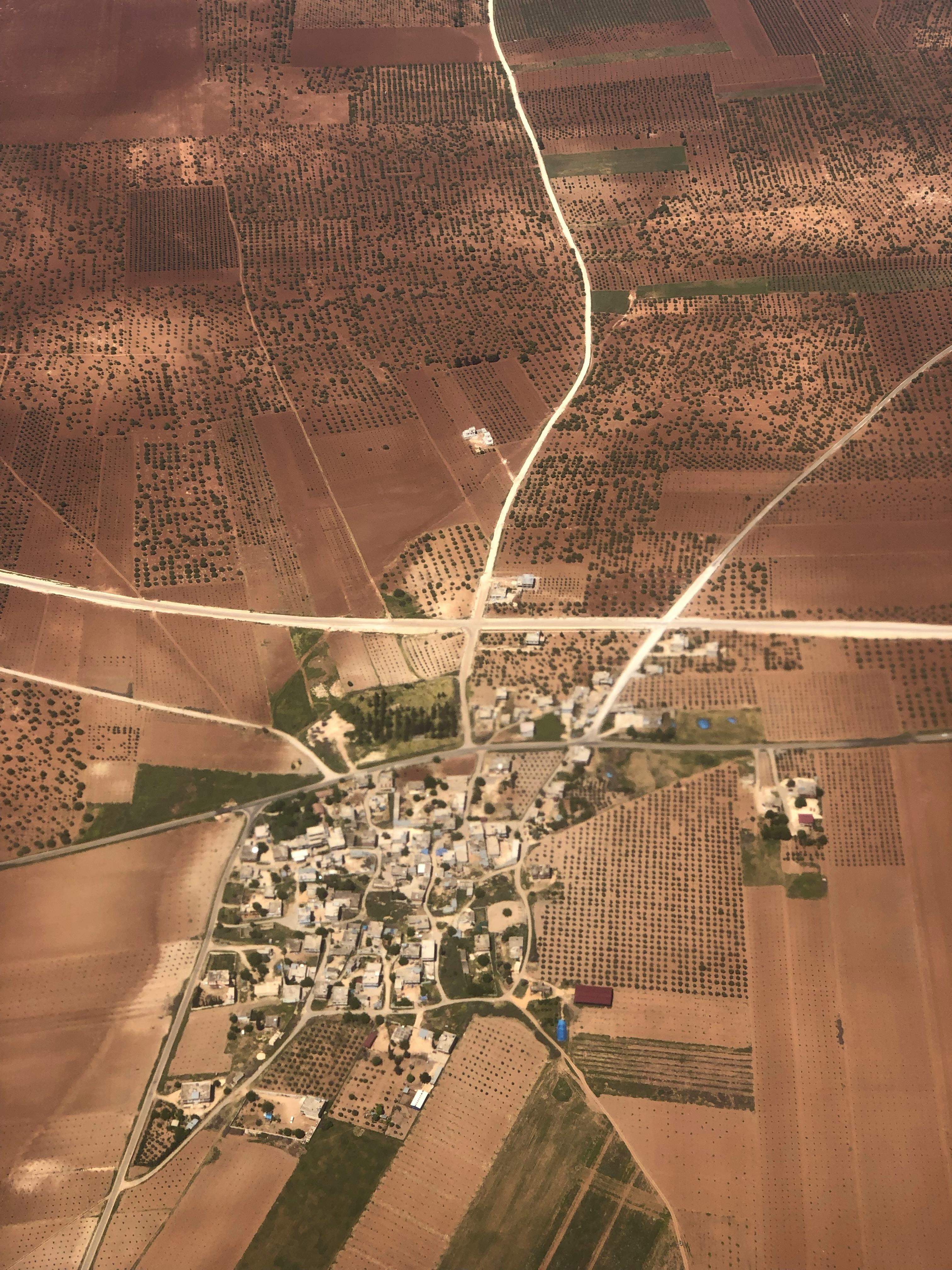 Aerial photo of a small town surrounded by expansive farmland and intersecting roads.