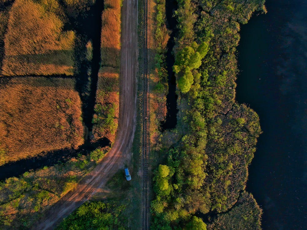 Free Aerial Photo of Blue Car Parked on Side of Road Stock Photo
