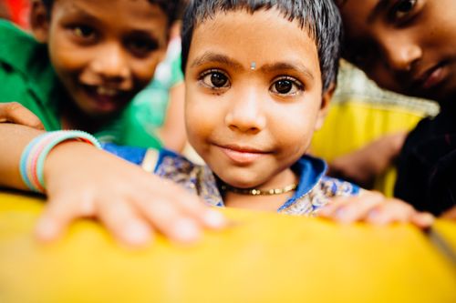 Free Close-up portrait of joyous Indian children enjoying outdoors, capturing innocence and happiness. Stock Photo