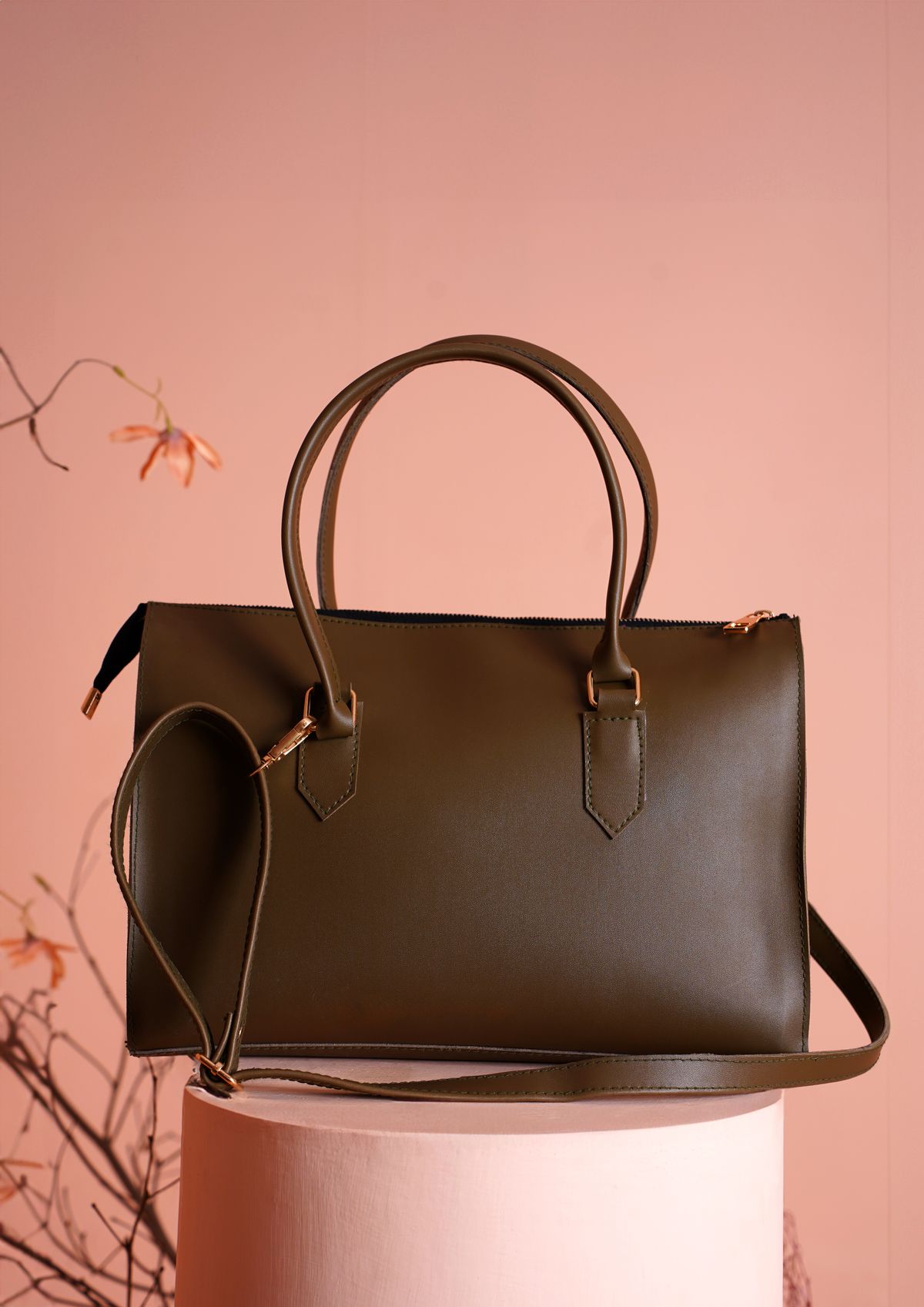 A refined brown leather handbag displayed against a neutral background