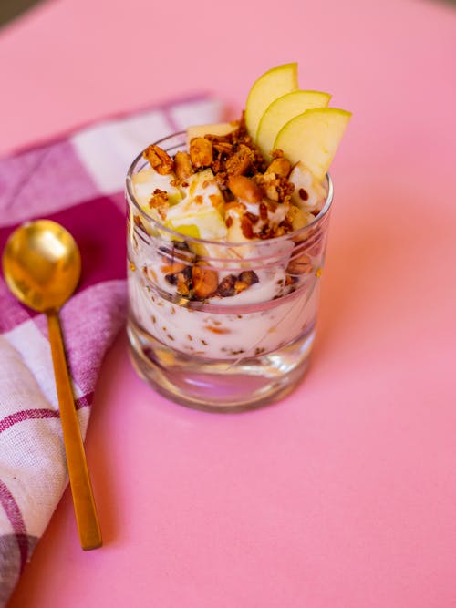 A small glass of yogurt with apples and nuts