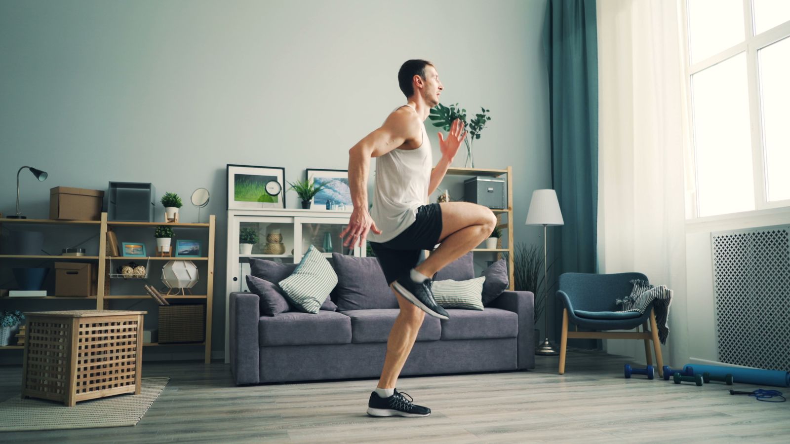 Person following an at-home exercise routine on a mat in a home living room
