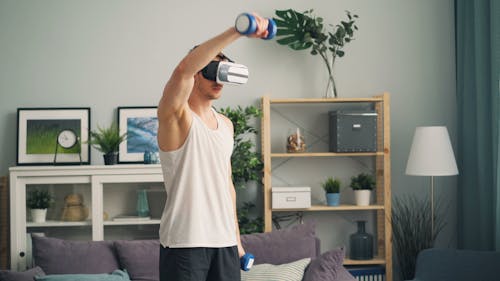 A man is using a vr headset to do exercises