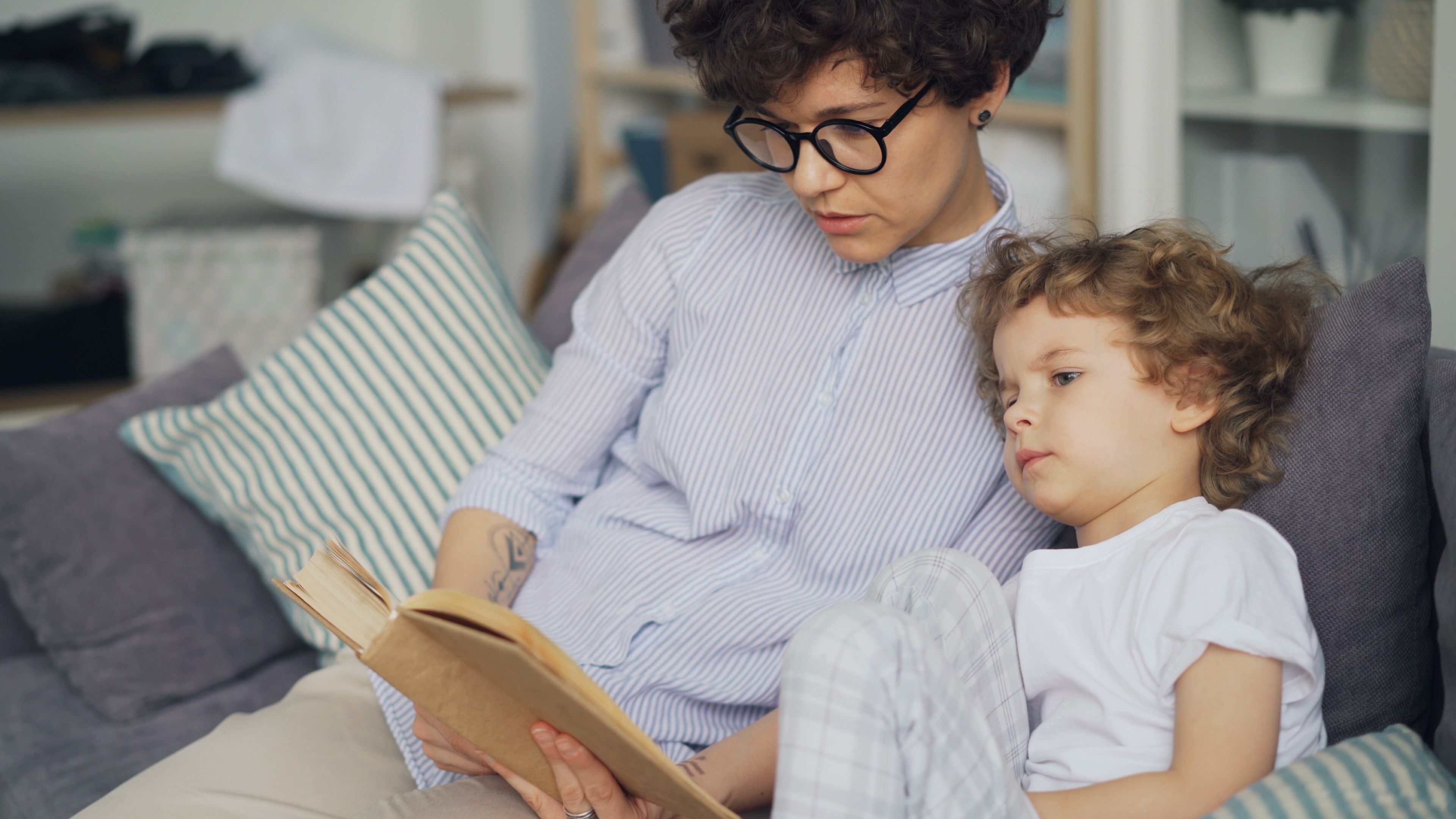 Woman Sitting with Son and Reading Book · Free Stock Photo