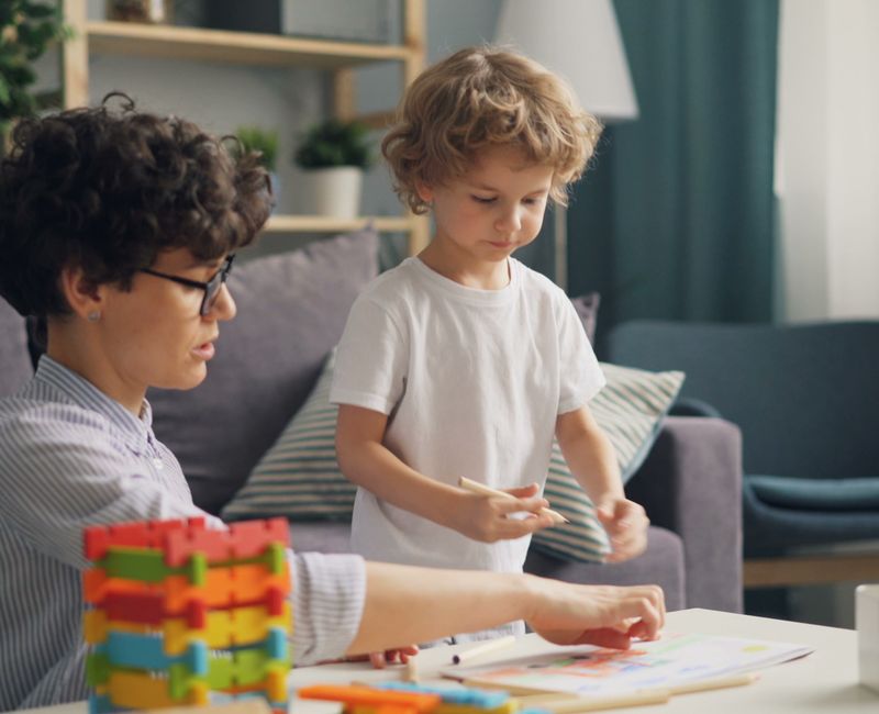 Child learning through ABA activities at home during summer break.