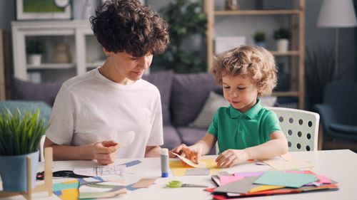 Free A mother and child enjoy a creative arts and crafts activity together at home. Stock Photo
