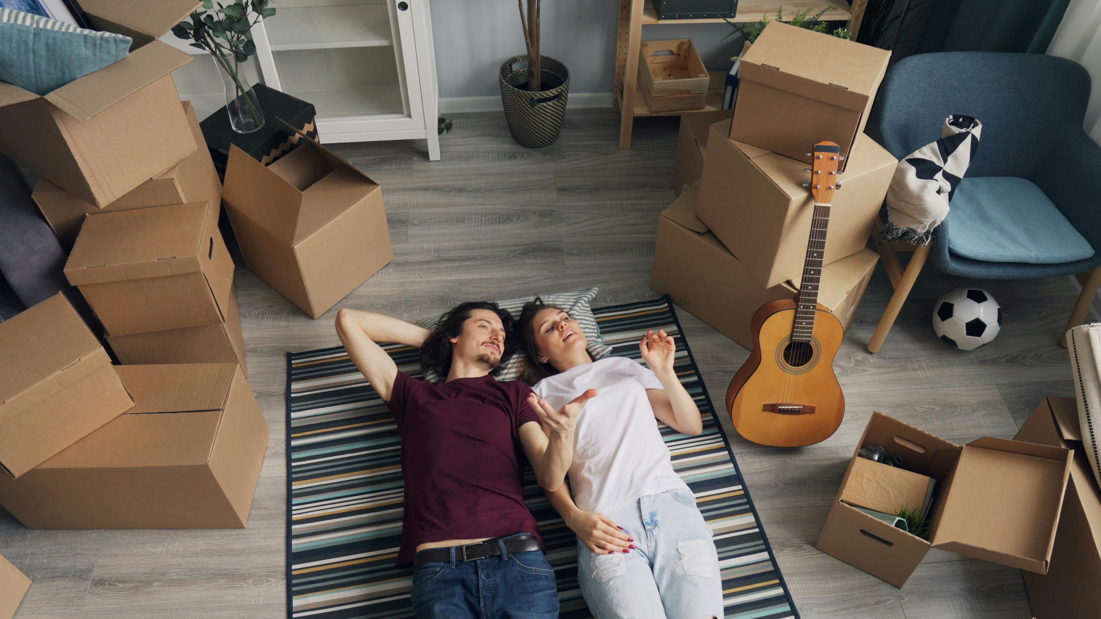 couple lying down on carpet in room