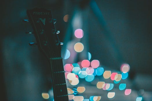 Artistic photo of guitar headstock with vibrant bokeh lights creating a dreamy musical ambiance.