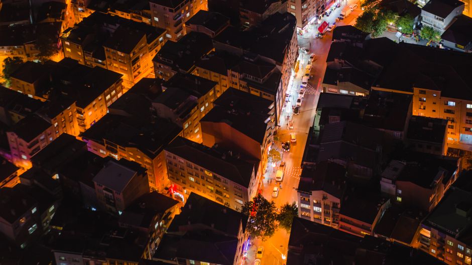 A vibrant aerial view of illuminated Istanbul streets and rooftops at night.