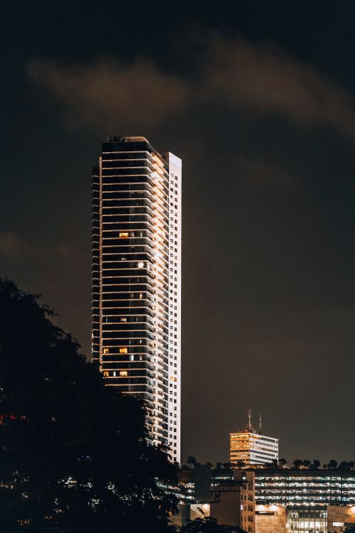 Free Tall skyscraper in Jakarta illuminated against the night sky, showcasing modern architecture. Stock Photo