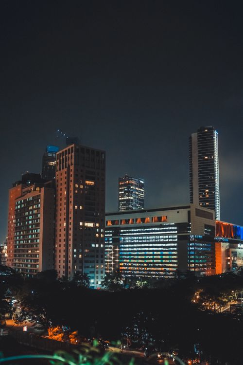Free Captivating view of Jakarta's cityscape with illuminated skyscrapers at night, offering a glimpse into urban life. Stock Photo