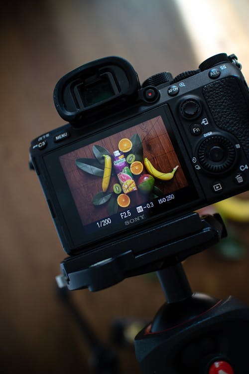 A camera with a lens on it and a banana on the table