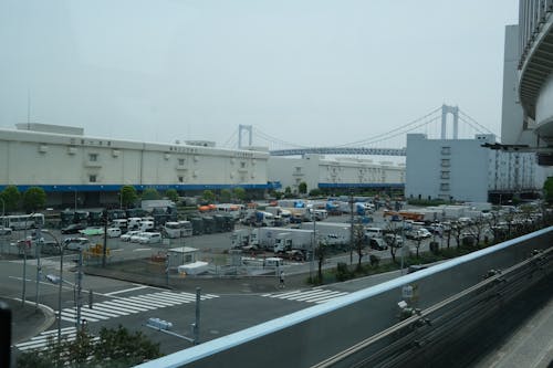 A view from a train window of a city and a bridge