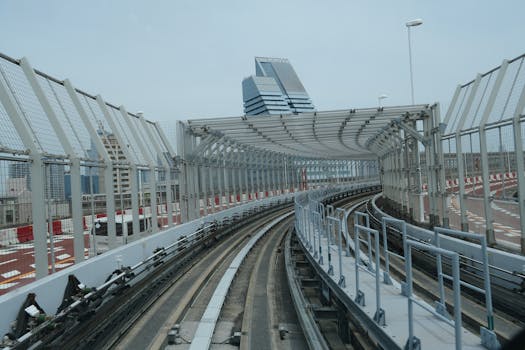 Curved railway track in Tokyo featuring modern architecture and urban design.