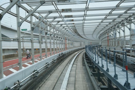 View of a curved railway track surrounded by barriers in Tokyo, Japan.