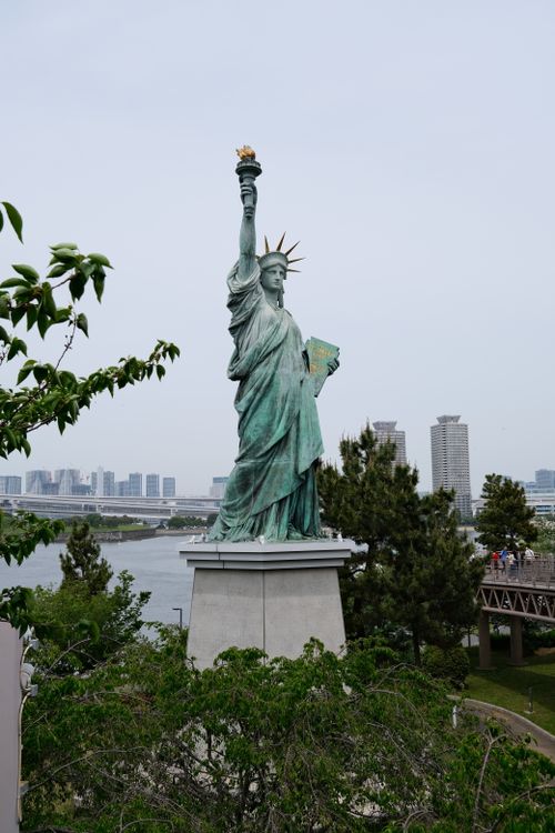 Free Replica of the Statue of Liberty located in Odaiba, Tokyo, with cityscape view. Stock Photo