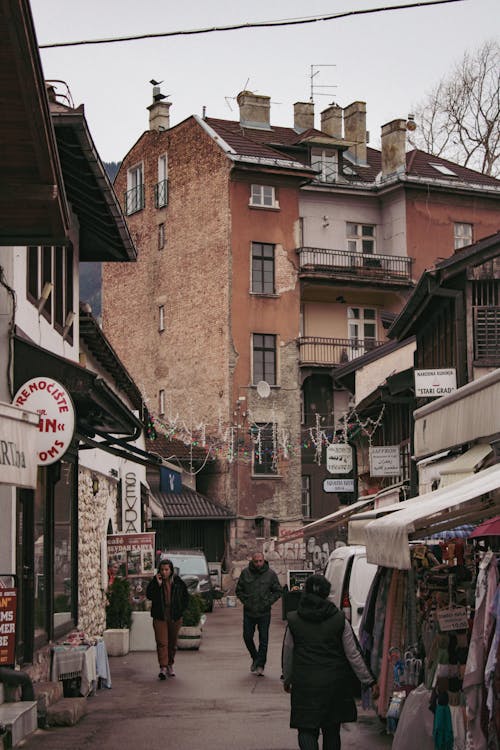 A street with people walking down it and buildings