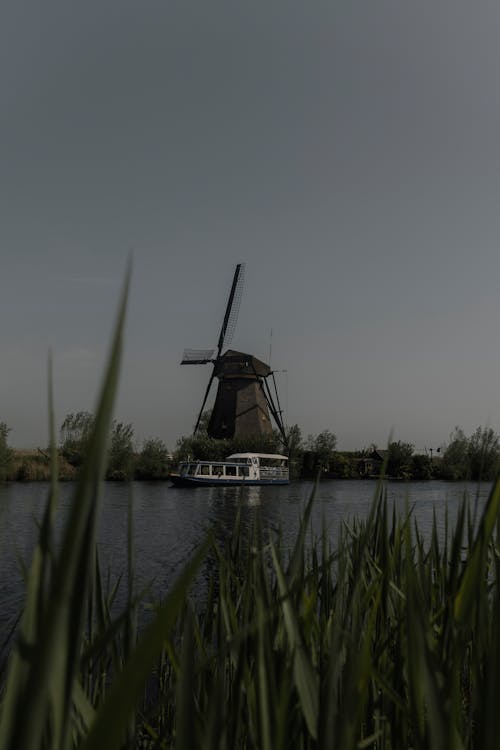 A windmill is sitting on top of a body of water