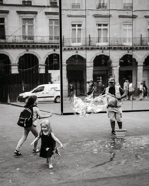 Free A man and two children playing in the street Stock Photo